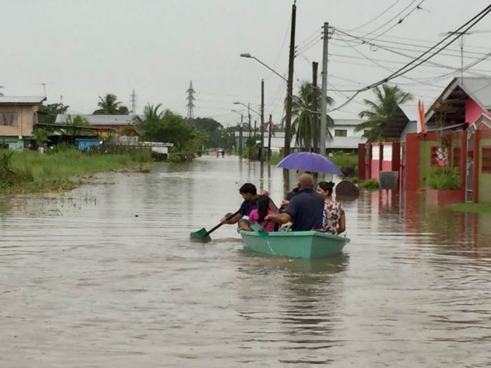 The failure of the ODPMTT left thousands affetce dby floods. Here a family uses a boat to traverse the deep flood waters.