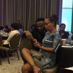 Nikki and Rodey check their phone.